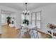 Bright dining area with modern lighting, and wood-style floors at 1481 Howard Way, Lawrenceville, GA 30043