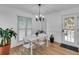Dining room with chandelier, wood flooring, and large windows, perfect for Gathering meals at 1481 Howard Way, Lawrenceville, GA 30043