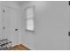 Hallway featuring a window, light wood floor, and white walls at 1481 Howard Way, Lawrenceville, GA 30043