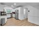 Modern kitchen with stainless steel appliances, white cabinets, and wood floors at 1481 Howard Way, Lawrenceville, GA 30043