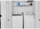Laundry room features white washer and dryer with white wire shelf at 1481 Howard Way, Lawrenceville, GA 30043