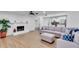 Bright living room with wood floors, fireplace, and an open floor plan to the kitchen at 1481 Howard Way, Lawrenceville, GA 30043