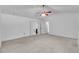 Main bedroom features neutral carpet, ceiling fan, and access to the main bathroom at 1481 Howard Way, Lawrenceville, GA 30043