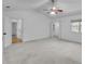Main bedroom features neutral carpet, ceiling fan, and access to closet and bathroom at 1481 Howard Way, Lawrenceville, GA 30043