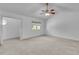 Main bedroom features neutral carpet, ceiling fan, and window with blinds at 1481 Howard Way, Lawrenceville, GA 30043
