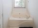 Cozy bathtub with window allowing for natural light and a place for relaxation at 2397 Planters Cove Dr, Lawrenceville, GA 30044