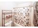 Compact bathroom showing a shower with a curtain, shelf, and a toilet providing essential amenities at 2397 Planters Cove Dr, Lawrenceville, GA 30044