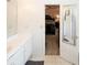 Bathroom area showcases an open door into the bedroom, plus white cabinets and countertops at 2397 Planters Cove Dr, Lawrenceville, GA 30044