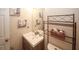 Charming half-bathroom with vanity and shelves for added style and functionality at 2397 Planters Cove Dr, Lawrenceville, GA 30044
