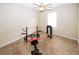 Bedroom converted into a small gym, equipped with workout equipment, and a ceiling fan at 2397 Planters Cove Dr, Lawrenceville, GA 30044
