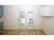 Dining area with double doors to the backyard, neutral walls, and tiled floor at 2397 Planters Cove Dr, Lawrenceville, GA 30044