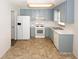 Functional kitchen with blue cabinets, white appliances, and ample counter space for meal preparation at 2397 Planters Cove Dr, Lawrenceville, GA 30044