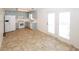 Bright kitchen featuring white appliances, blue cabinets, and access to the exterior via double doors at 2397 Planters Cove Dr, Lawrenceville, GA 30044