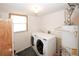 Bright laundry room featuring modern washer and dryer and a traditional water heater at 2397 Planters Cove Dr, Lawrenceville, GA 30044