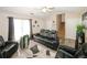 Comfortable living room featuring fireplace, staircase, and contemporary black leather seating at 2397 Planters Cove Dr, Lawrenceville, GA 30044