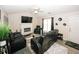 Bright living room showcasing a fireplace, vaulted ceiling, and stylish black leather seating at 2397 Planters Cove Dr, Lawrenceville, GA 30044