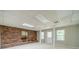 Spacious basement with brick accent wall, neutral carpet, and finished ceiling at 4989 Woodfall Sw Dr, Lilburn, GA 30047