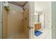 Shower and vanity area, with a walk-in shower and patterned wallpaper at 4989 Woodfall Sw Dr, Lilburn, GA 30047