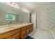 Bathroom featuring a double vanity, a soaking tub, and floral wallpaper at 4989 Woodfall Sw Dr, Lilburn, GA 30047
