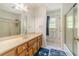 Bathroom with a tub, shower, vanity, and nautical themed rug at 4989 Woodfall Sw Dr, Lilburn, GA 30047