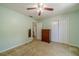 Bedroom features carpet, closet, a window, and light green walls at 4989 Woodfall Sw Dr, Lilburn, GA 30047