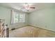 Bedroom with carpeted floors and a window at 4989 Woodfall Sw Dr, Lilburn, GA 30047