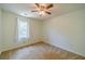 Simple bedroom featuring neutral carpet and a window at 4989 Woodfall Sw Dr, Lilburn, GA 30047