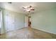 Bedroom with a neutral interior, ceiling fan, and double-door closet for ample storage at 4989 Woodfall Sw Dr, Lilburn, GA 30047