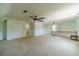 Large bonus room featuring wall-to-wall neutral carpet and a ceiling fan at 4989 Woodfall Sw Dr, Lilburn, GA 30047