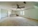 Large bonus room with two ceiling fans and neutral carpet at 4989 Woodfall Sw Dr, Lilburn, GA 30047