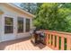 Wooden deck with a grill and seating area, perfect for outdoor entertaining at 4989 Woodfall Sw Dr, Lilburn, GA 30047