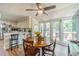 Bright dining area features a ceiling fan, wood floors, large windows, and access to a patio deck at 4989 Woodfall Sw Dr, Lilburn, GA 30047