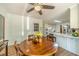 Dining area features a wood table, hardwood floors, and views into the kitchen at 4989 Woodfall Sw Dr, Lilburn, GA 30047