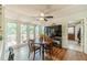 The dining area features hardwood floors, large windows, and access to an outdoor deck at 4989 Woodfall Sw Dr, Lilburn, GA 30047