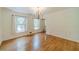 Charming dining room with hardwood floors, wainscoting, large windows and chandelier at 4989 Woodfall Sw Dr, Lilburn, GA 30047