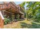 Exterior of the home showcasing a two-story deck and enclosed porch, surrounded by landscaping at 4989 Woodfall Sw Dr, Lilburn, GA 30047