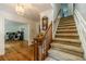 Inviting foyer with hardwood floors and a staircase, showcasing the home's classic design at 4989 Woodfall Sw Dr, Lilburn, GA 30047