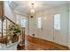 Elegant foyer features hardwood floors, stairs, and a front door with sidelights at 4989 Woodfall Sw Dr, Lilburn, GA 30047