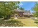 Charming two-story brick home with mature trees and manicured landscaping at 4989 Woodfall Sw Dr, Lilburn, GA 30047