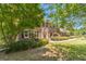 Beautiful brick home on a landscaped lot, featuring a well-maintained lawn at 4989 Woodfall Sw Dr, Lilburn, GA 30047