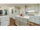 Cozy kitchen with white cabinetry and kitchen island with seating at 4989 Woodfall Sw Dr, Lilburn, GA 30047