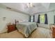 Spacious bedroom with multiple windows, carpet and tray ceilings at 4989 Woodfall Sw Dr, Lilburn, GA 30047