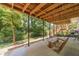 Covered patio space with a swing, concrete flooring, and view of the backyard at 4989 Woodfall Sw Dr, Lilburn, GA 30047