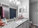 Modern bathroom features vanity with granite countertop and framed mirror at 102 Oak Pl, Villa Rica, GA 30180