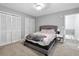 Relaxing bedroom features natural light, closet, and neutral carpet at 102 Oak Pl, Villa Rica, GA 30180