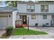 Charming two-story townhome featuring a welcoming front porch, siding, and well-manicured lawn at 102 Oak Pl, Villa Rica, GA 30180