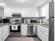Well-appointed kitchen with white cabinets, granite countertops, and stainless steel appliances at 102 Oak Pl, Villa Rica, GA 30180