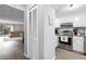 Open kitchen view with white cabinets and stainless steel appliances and eat-in dining at 102 Oak Pl, Villa Rica, GA 30180
