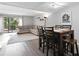 Open-concept living room features a dining area and access to an outdoor deck with wooded views at 102 Oak Pl, Villa Rica, GA 30180
