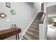 Inviting stairway with carpeted steps and contemporary decor leading to the upper level at 102 Oak Pl, Villa Rica, GA 30180